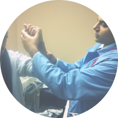 Student testing the muscle strength of a patient